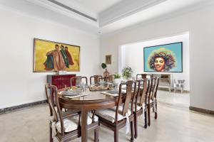a dining room with a table and chairs at VayK - Magnificent 5 BD Villa with Private Pool in Dubai