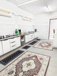 a kitchen with two rugs on the floor at Homestay Temerloh Nasuha Homestay For Muslim Near Hospital with Private Pool Wi-Fi Netflix in Temerloh
