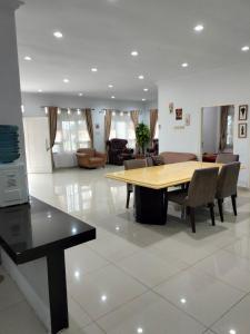 a living room with a wooden table and chairs at VILLA KID HOUSE BOGOR in Gununggeulis