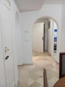 a hallway with a white door and a floor at إقامة النسرين in Yasmine