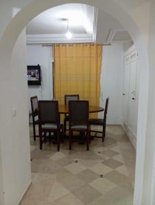 a dining room with a table and chairs at إقامة النسرين in Yasmine