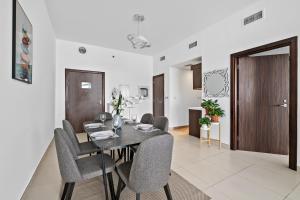 a dining room with a table and chairs at VayK - Serene 1BD with Full Sea View on the Palm in Dubai