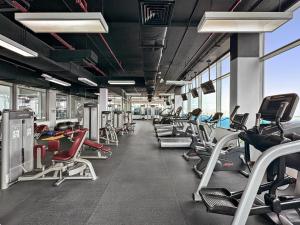 a gym with a lot of people exercising on machines at VayK - Serene 1BD with Full Sea View on the Palm in Dubai