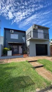 a house with a large yard in front of it at Departamento los hermanos in Concepción del Uruguay