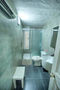 a bathroom with a shower and a toilet and a sink at Charming 3 storey apartment in Valletta centre, NGRI1-1 in Valletta +23 photos