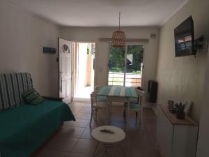 a living room with a table and a couch at Hermoso Duplex familiar en Zona Norte in Mar del Plata