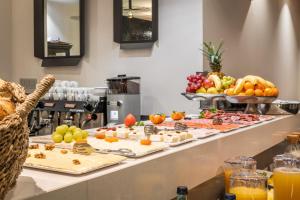 a buffet line with many different types of food at Arya Stadium Hotel in Barcelona