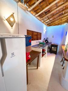 uma cozinha com um frigorífico e uma mesa em Atins Beach Houses em Atins