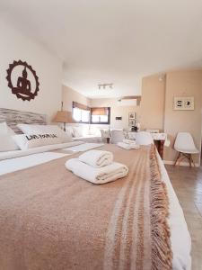 a large bedroom with two large beds with white sheets at Rincón de Paz Apart & Loft Suite Boutique - Adults Only in Villa Carlos Paz