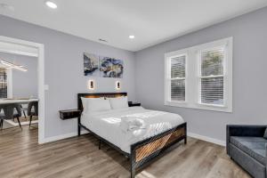 a bedroom with a bed and a couch at Spacious House in Charlotte in Charlotte +34 photos