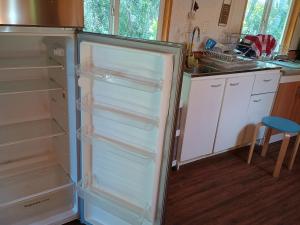 a refrigerator with its door open in a kitchen at Lago Ranco, Casa en la montaña camino el Arenal in Ranco