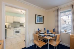 a kitchen and dining room with a table and chairs at Pretty Apartment in the Cathedral City of Ripon in Ripon