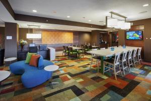 a hotel lobby with a table and chairs at Fairfield Inn by Marriott East Rutherford Meadowlands in East Rutherford