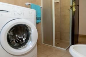 a washing machine in a bathroom with a shower at A casa di Franco e Rosa in Leuca