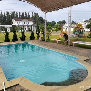 a large swimming pool with a slide and a playground at VILLA KID HOUSE BOGOR in Gununggeulis