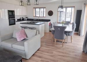 a living room and kitchen with a couch and a table at Cherry Bird Country Park in Newbury