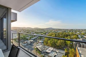 an apartment balcony with a view of a city at Stunning cityview 1BR Apt, 1 min to train in Brisbane
