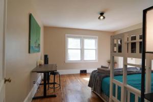 a bedroom with a bunk bed and a desk at Trail-Ready Retreat near Waterfalls w/ Hot Tub in Brevard
