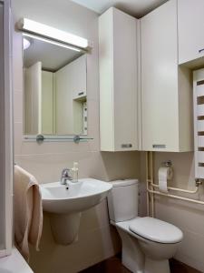 a white bathroom with a toilet and a sink at Cozy Apartment SOFI in Belville in Novi Beograd