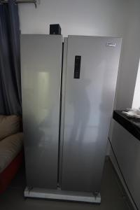 um frigorífico de aço inoxidável num quarto em Villa Sol Taino, Hotel en Boca chica, 5 minutos del Aeropuerto Internacional las Américas em La Golondrina