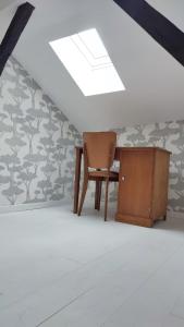 an attic room with a desk and a chair at Maison Charmeilles - Suite Montagne Saint Emilion in Fronsac