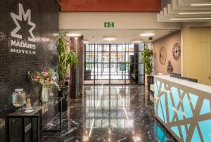 a lobby of a hotel with a reception desk at Arya Stadium Hotel in Barcelona