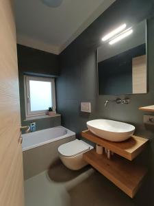 a bathroom with a white sink and a toilet at Casa vacanze Da Bianca in Castelfondo