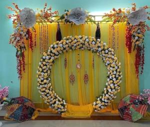 a room with areath of flowers on a curtain at ATULYAM HARSHADA STAYS LUCKNOW in Goshainganj