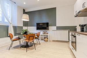 a kitchen and dining room with a table and chairs at Discover Apartment in Livorno