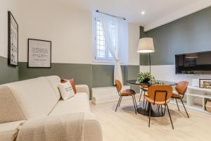 a living room with a couch and a table at Discover Apartment in Livorno