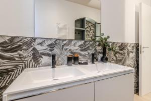 a bathroom with a sink and a mirror at Discover Apartment in Livorno
