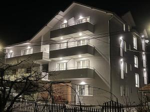 a building at night with lights on at Smeštaj Milutinn, centar Sokobanje, iza Miloševog konaka in Soko Banja +73 photos