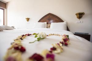 a bed with flowers on top of it at Dar Zayane in Khenifra