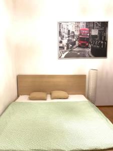 a bedroom with a bed with a double decker bus at FlatMetro Rooms in Budapest