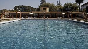 a large pool of water in front of a building at Curia Palace, Hotel & Spa in Curia
