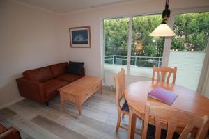 a living room with a table and a couch at Apartment zum See in Ascheberg