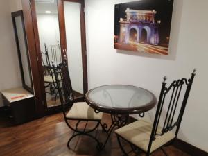 a room with a glass table and two chairs at Holiday Inn Hotel & Suites Centro Historico, an IHG Hotel in Guadalajara