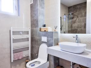 a bathroom with a white toilet and a sink at Vucko Slopes Apartment Bjelasnica in Bjelašnica +22 photos