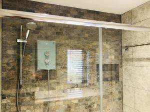 a shower in a bathroom with a glass door at Still Waters in Hill Head