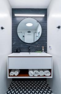 a bathroom with a sink and a mirror at Beachfront Boutique Apartment in Herzliya