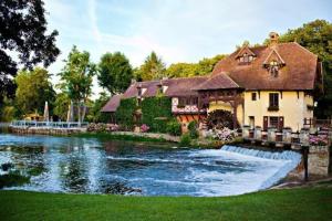 a large house with a river in front of it at Maison Aveny Spa in Aveny