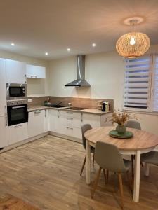 uma cozinha com uma mesa de madeira e uma sala de jantar em l’Anita em Théoule-sur-Mer