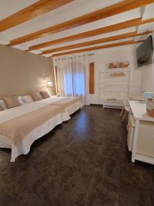 a large bedroom with two beds and a television at Villa Morena in Finestrat