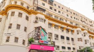 a large white building with a gold trim at Bengal Chambers in Kolkata