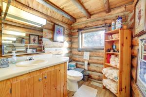 a log cabin bathroom with a sink and a toilet at Yellowstone Cabin Getaway Near National Park in Cliff Lake +21 photos