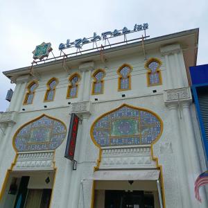 a building with birds sitting on top of it at Hotel Zara in Sungai Petani