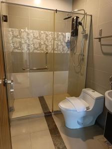 y baño con ducha, aseo y lavamanos. en Hotel Zara, en Sungai Petani