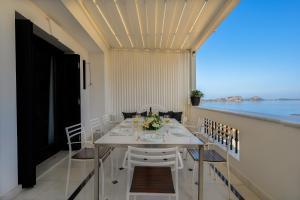 a dining room with a table and chairs and the ocean at Seaside Resort Home in Pylos