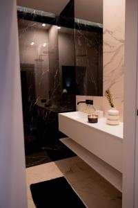 a bathroom with a white sink and a mirror at Rentroom2 in Polanica-Zdrój
