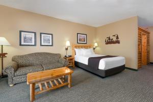 a hotel room with a bed and a couch at Great Wolf Lodge Southern California in Anaheim +8 photos
